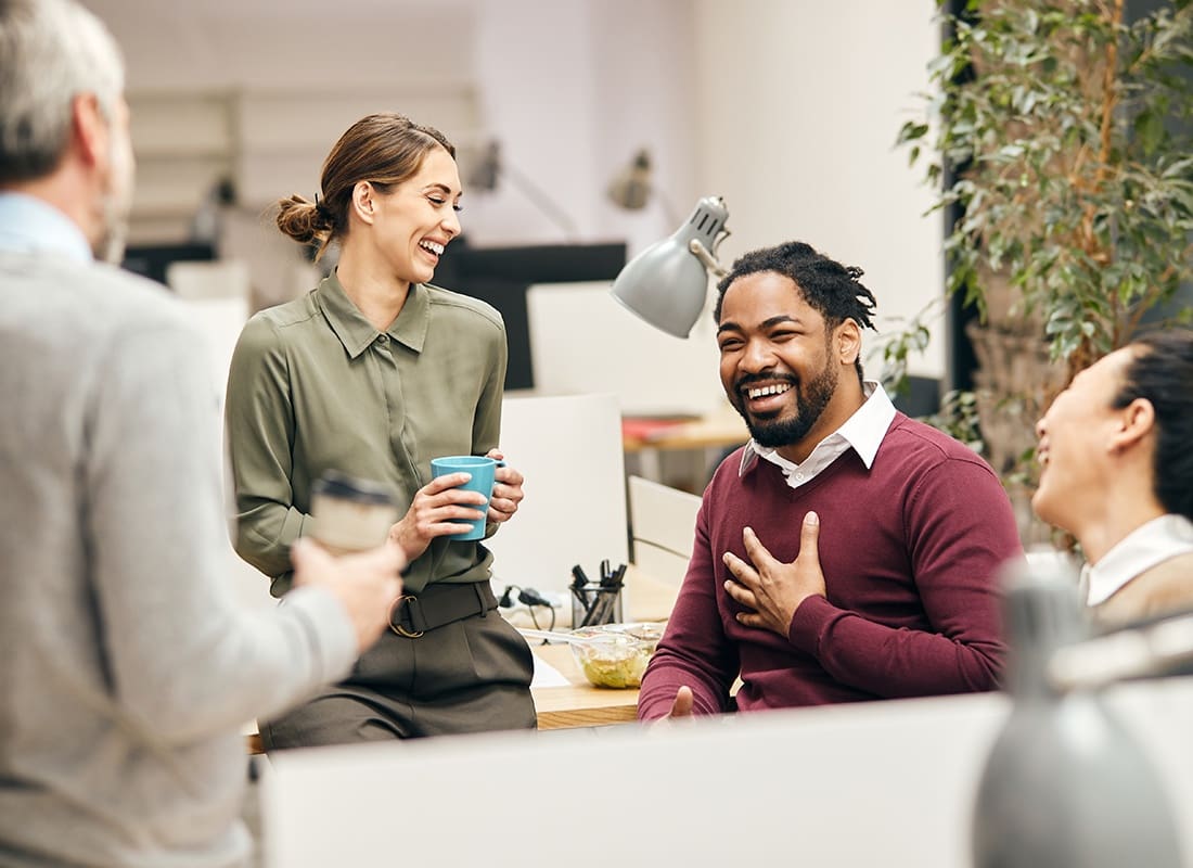 About Our Agency - Group of Professionals Laugh and Talk Together in Their Office