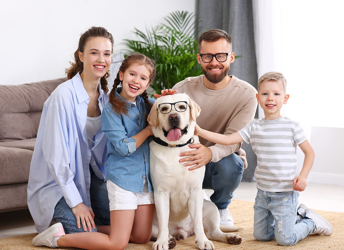 Personal Insurance - Family and Their Dog Sitting Together With Glasses